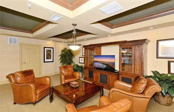 a living room with furniture a flat screen tv and a window