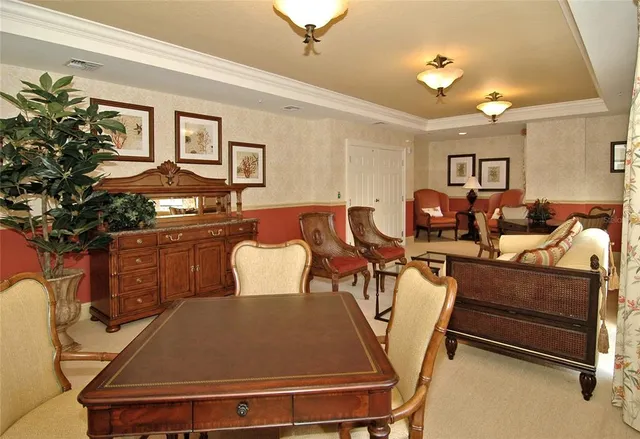 a living room with furniture a chandelier and a dining table