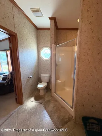 a bathroom with a glass door shower