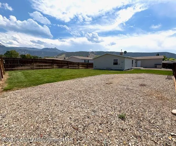 a view of a backyard of the house