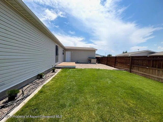 a view of a backyard with sitting area