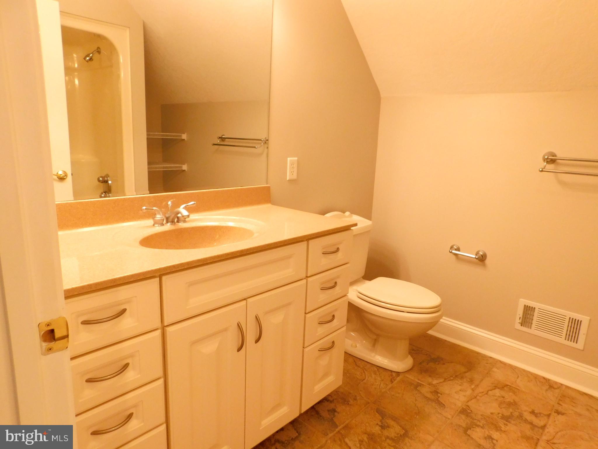 487 Brookfield Drive Dover, DE 19901 - Photo 22 of 45 a bathroom with a granite countertop toilet sink and mirror