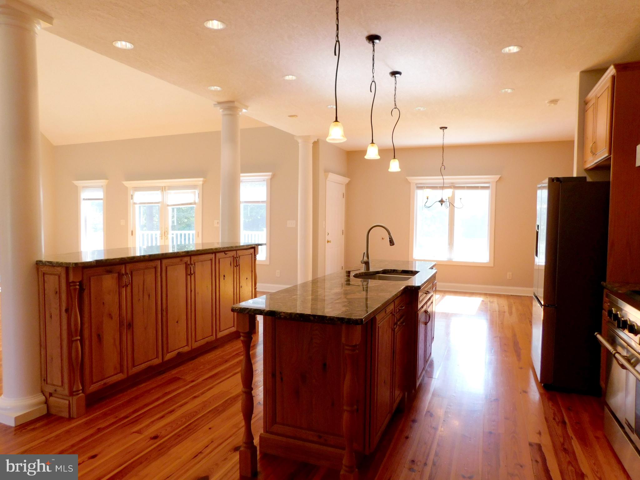 487 Brookfield Drive Dover, DE 19901 - Photo 27 of 45 a kitchen with stainless steel appliances granite countertop wooden floors wooden cabinets a sink and a stove