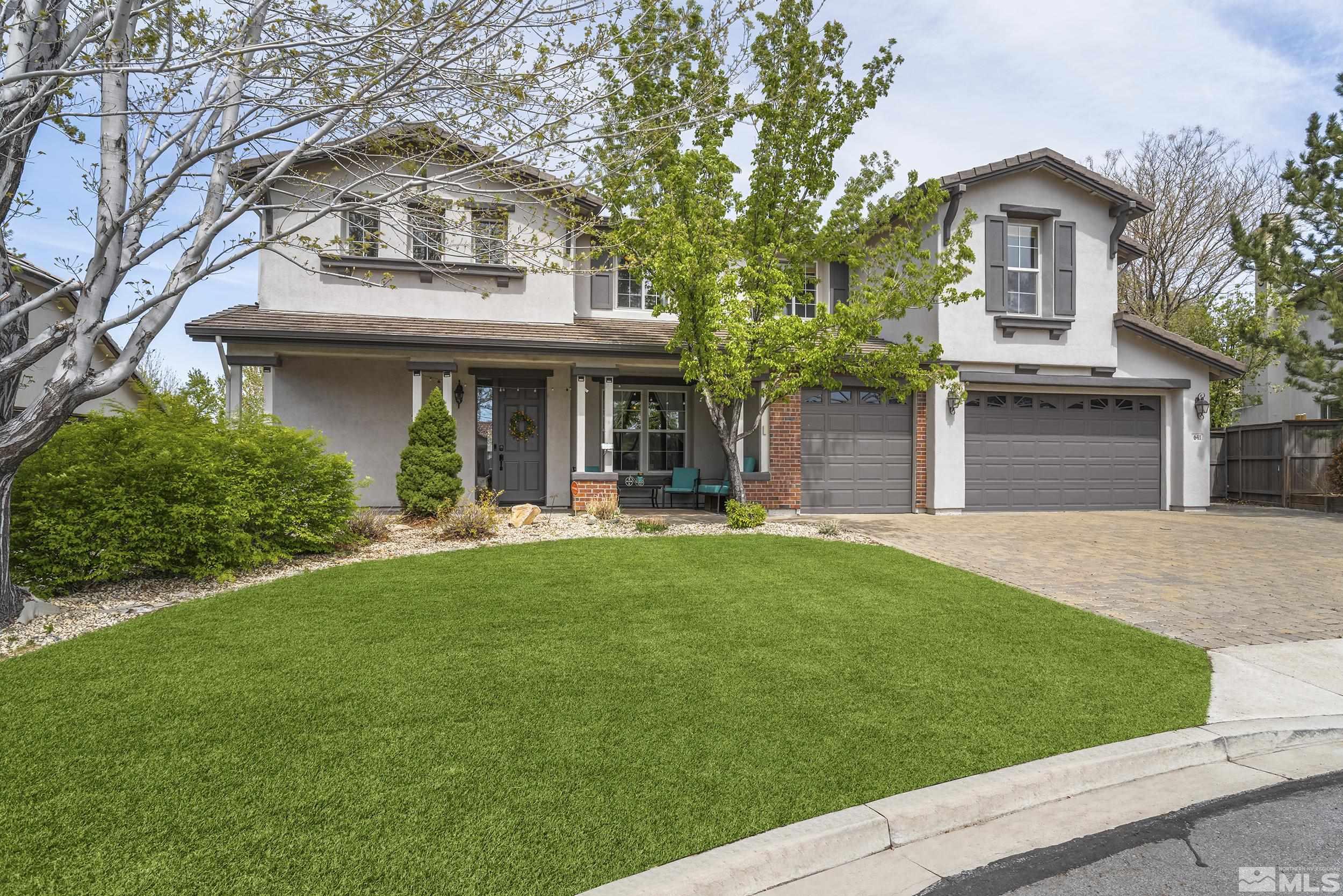a view of a house with a yard and plants
