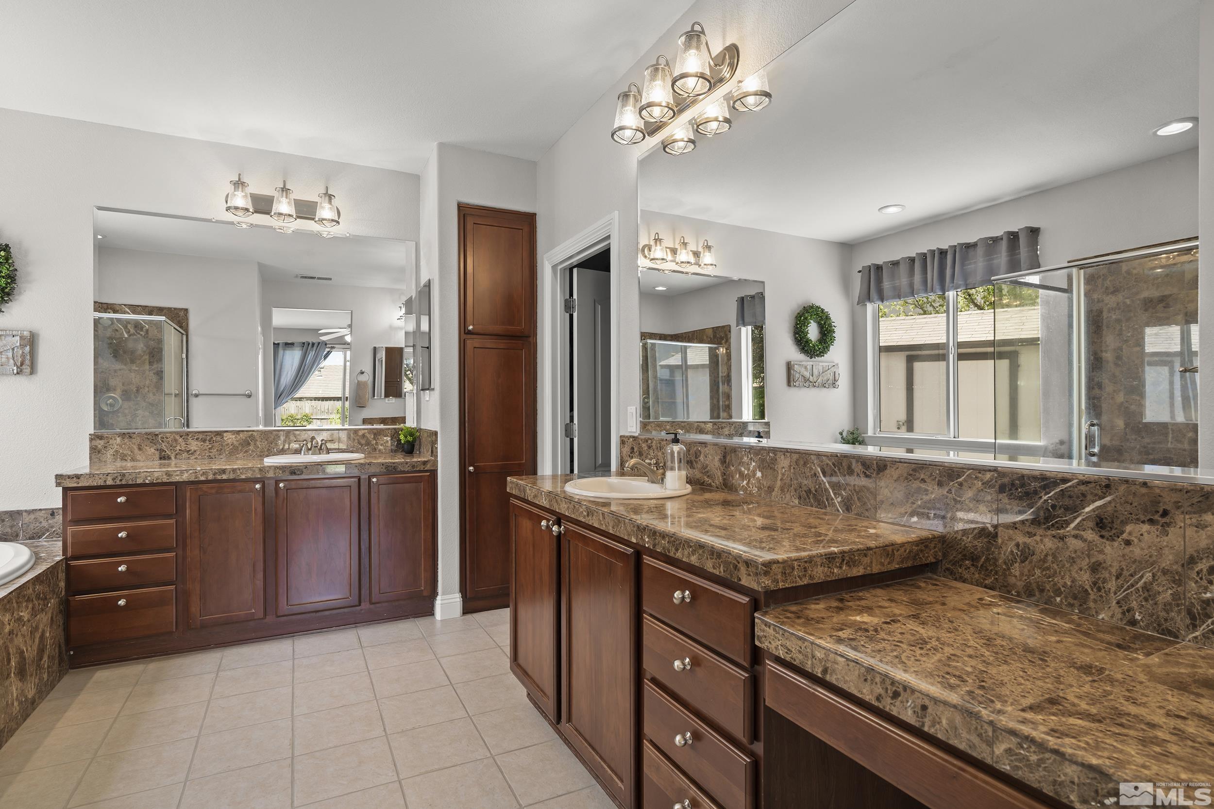 641 Aberdeen Court Reno, NV 89521 - Photo 15 of 39 a bathroom with a granite countertop sink a mirror and a vanity