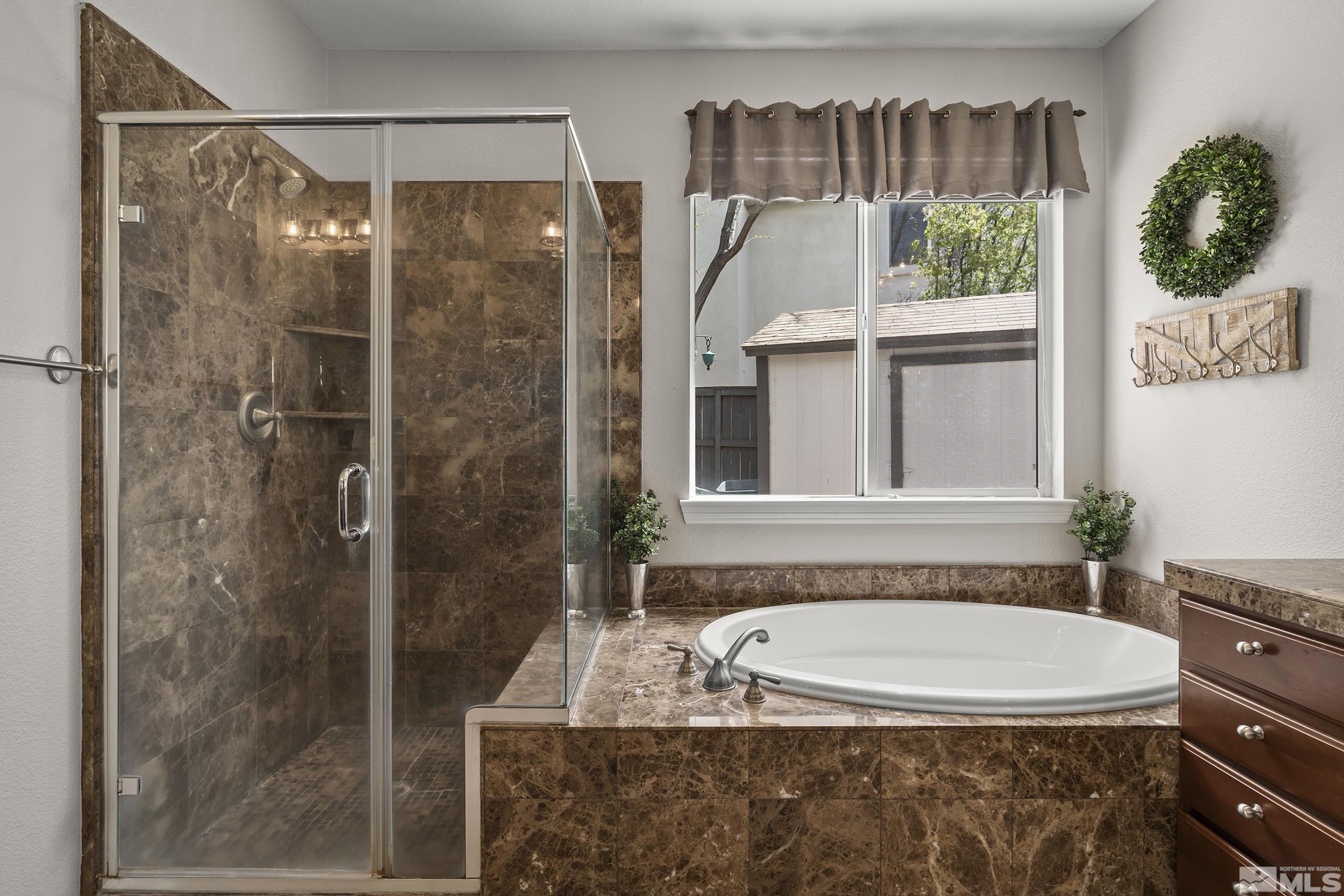 641 Aberdeen Court Reno, NV 89521 - Photo 16 of 39 a bathroom with a granite countertop bathtub and shower