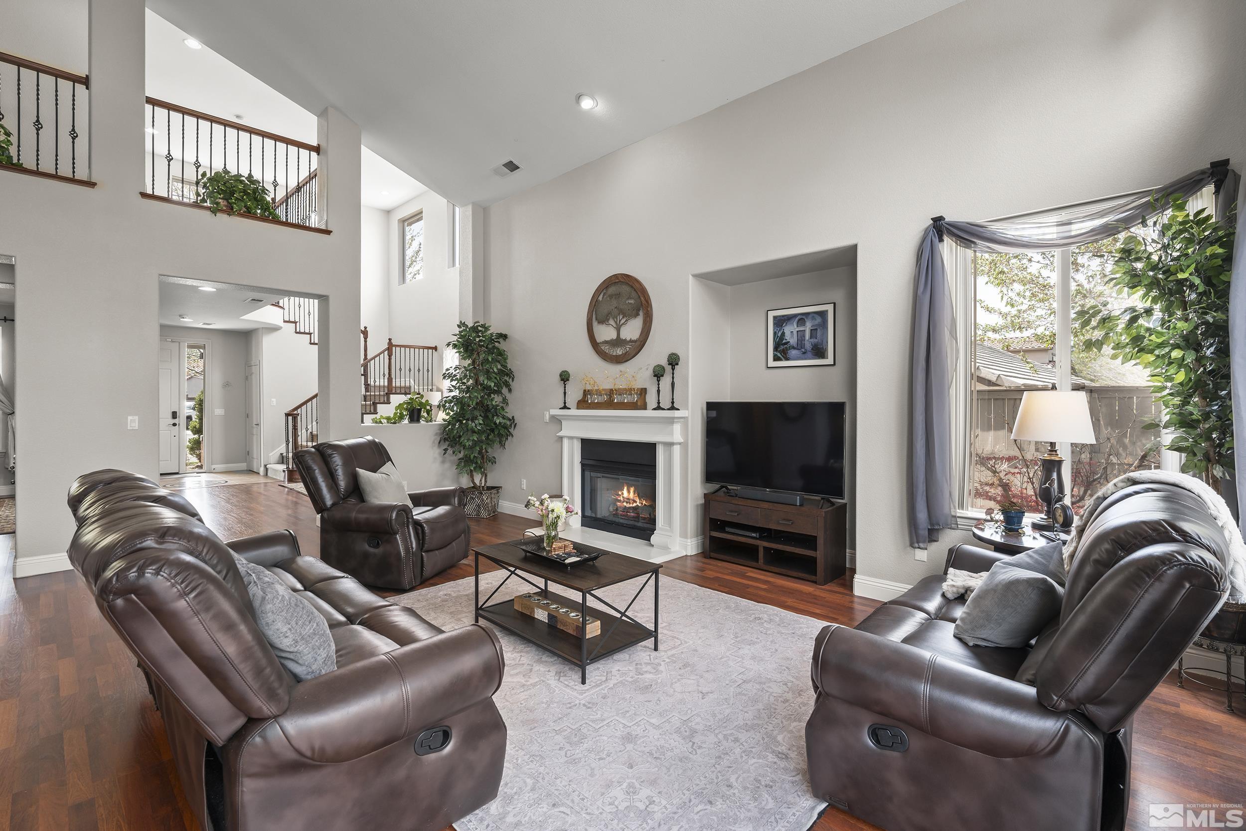 641 Aberdeen Court Reno, NV 89521 - Photo 6 of 39 a living room with furniture a large window and a fireplace