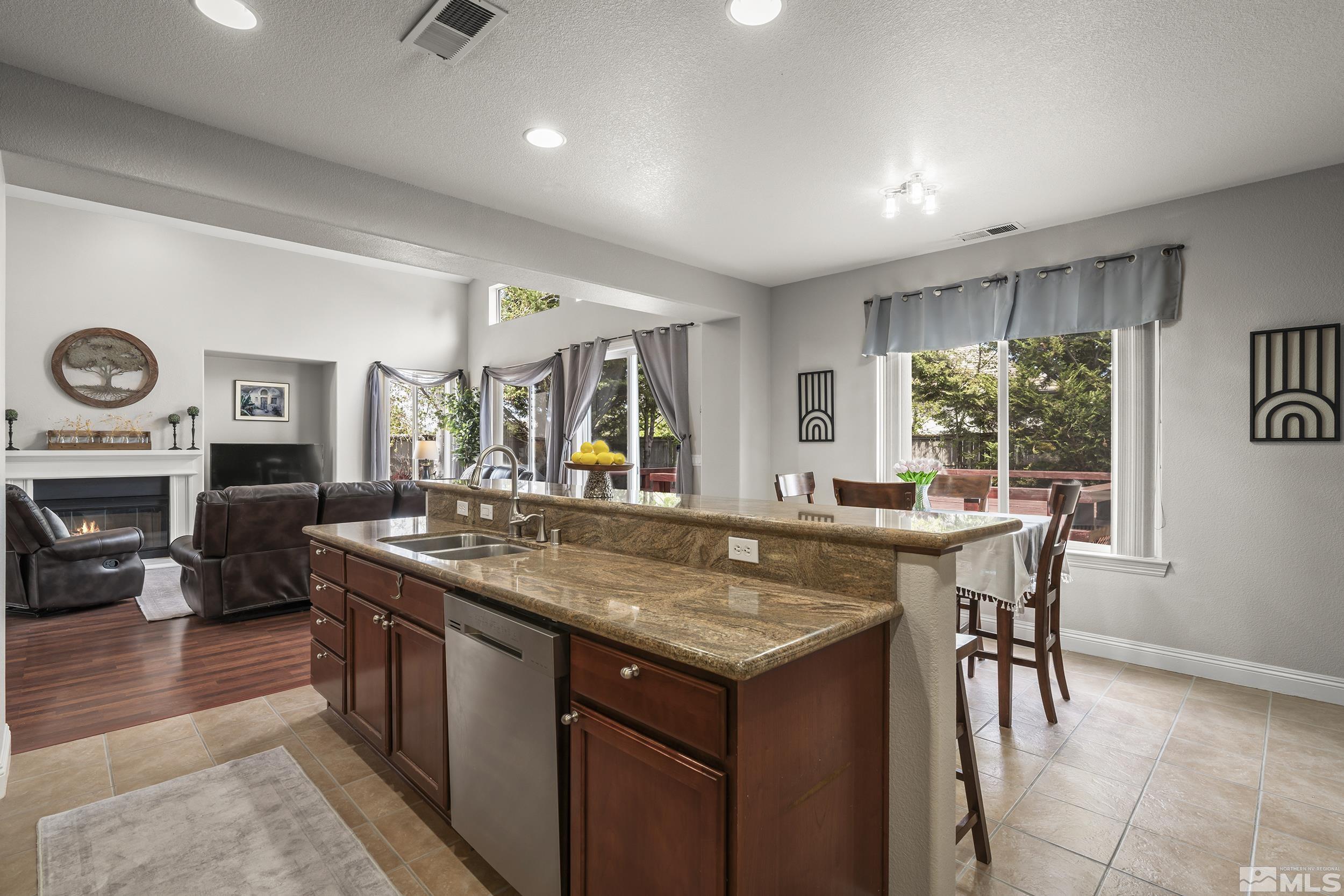 641 Aberdeen Court Reno, NV 89521 - Photo 9 of 39 a dining hall with stainless steel appliances granite countertop a stove and a large window