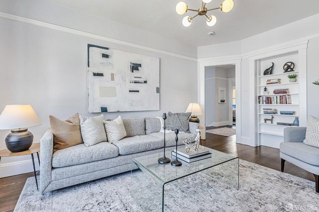 a living room with furniture a rug and a window