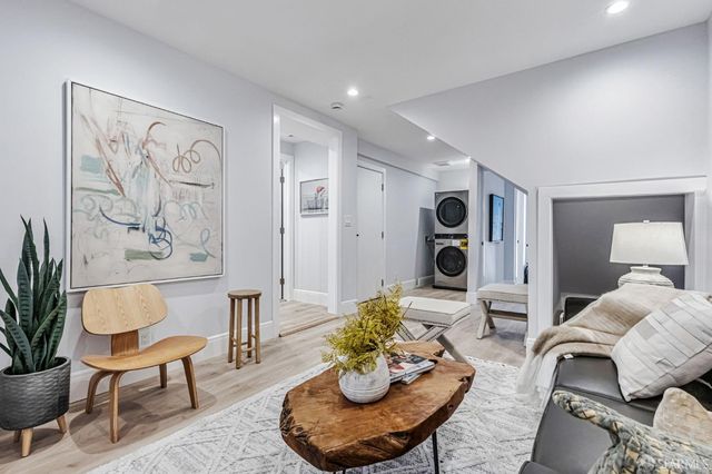 a living room with furniture potted plant and a lamp