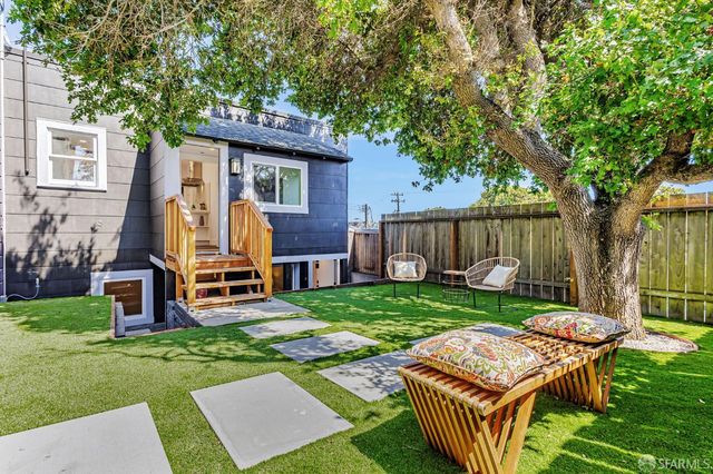 a backyard of a house with table and chairs