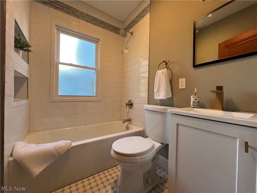 4523 Maplecrest Avenue Parma, OH 44134 - Photo 18 of 31 Full bathroom featuring tile flooring, tiled shower / bath combo, vanity, and toilet