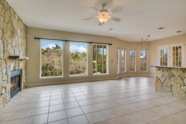 a view of an empty room with a fireplace and a large window