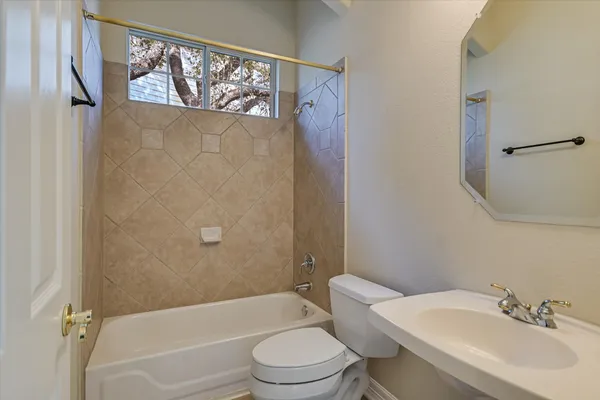 a bathroom with a toilet and a tub