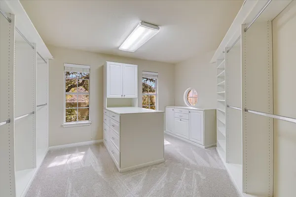 a view of kitchen cabinets and window