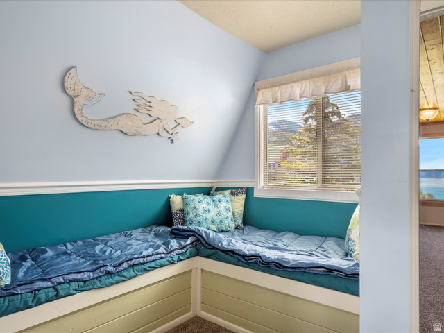 371 Lewis Loop, Unit 29 Fish Haven, ID 83287 - Photo 32 of 40 Built-in L-shaped window bench with a light green base, providing seating and a window with horizontal blinds