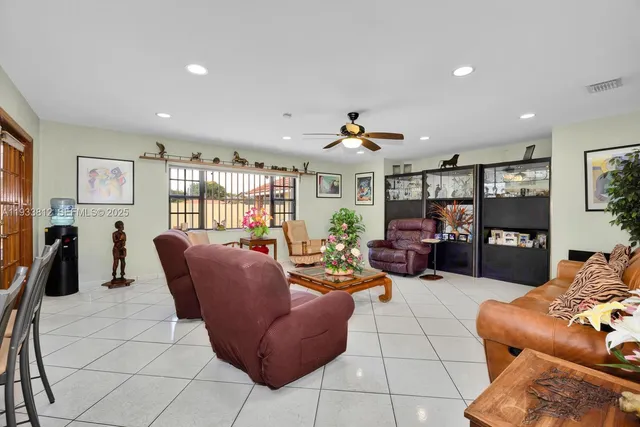a living room with furniture a rug and a chandelier