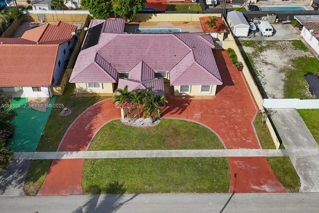 an aerial view of houses with yard