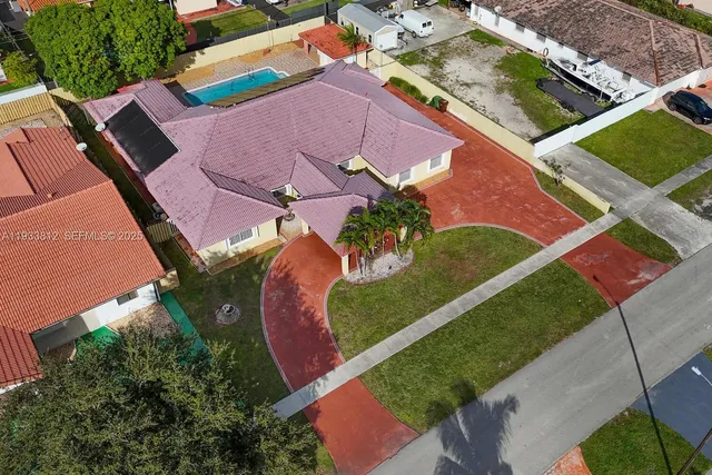 an aerial view of a house with a big yard