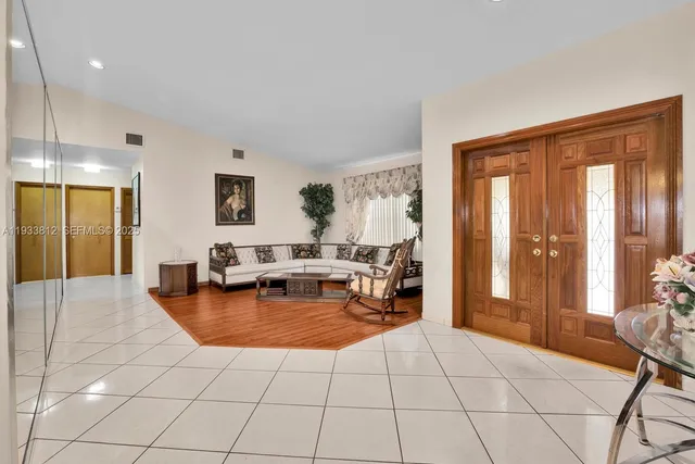 a living room with furniture and large windows