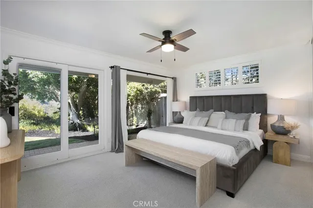 a bedroom with a large bed and a large window