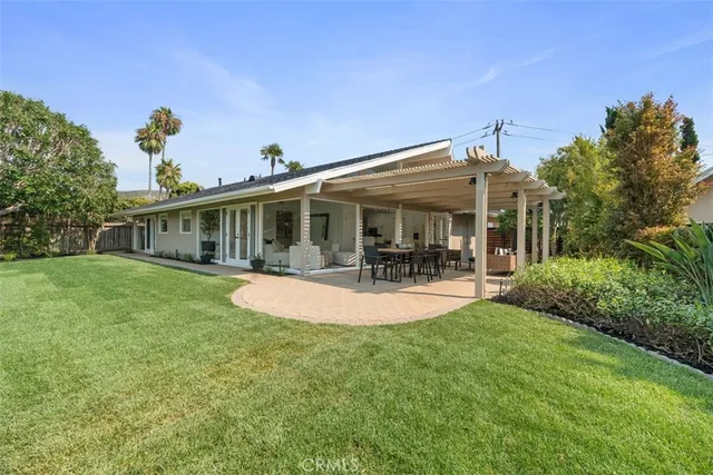 a patio with glass top table and chairs