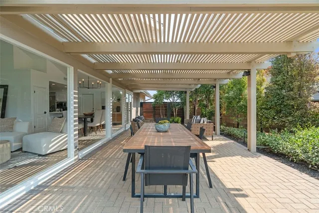 a living room with furniture and floor to ceiling window