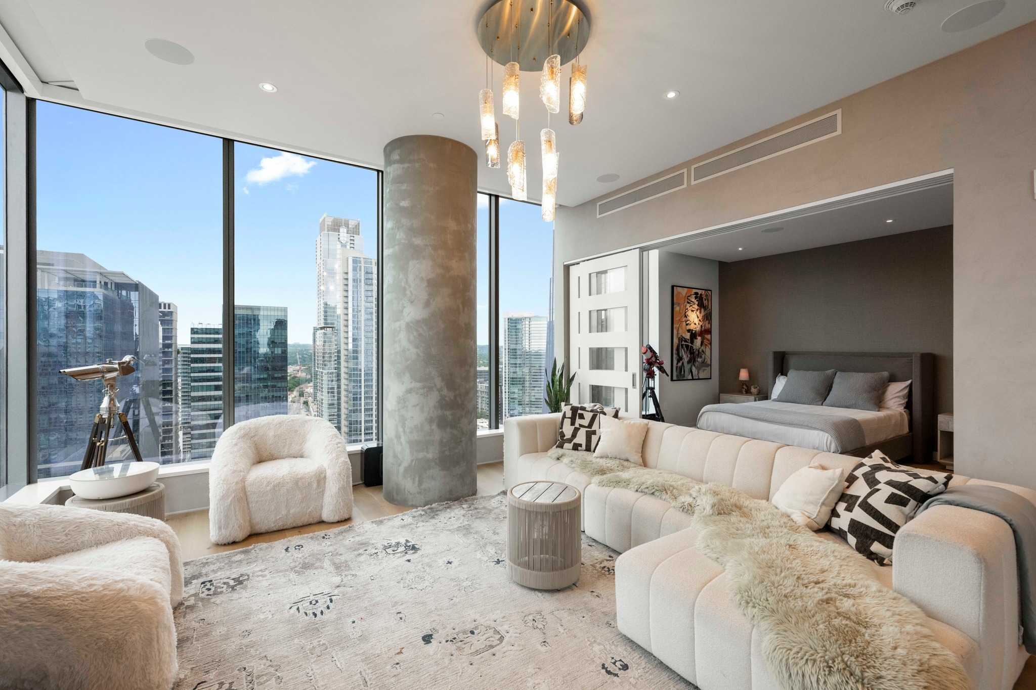 210 Lavaca Street, Unit 2706 Austin, TX 78701 - Photo 9 of 32 Open concept living area with expansive floor-to-ceiling windows, showcasing cityscape architecture