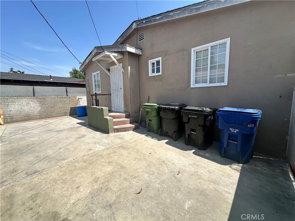 10516 Clovis Avenue Los Angeles, CA 90002 - Photo 12 of 13 a bedroom with a bed and dresser