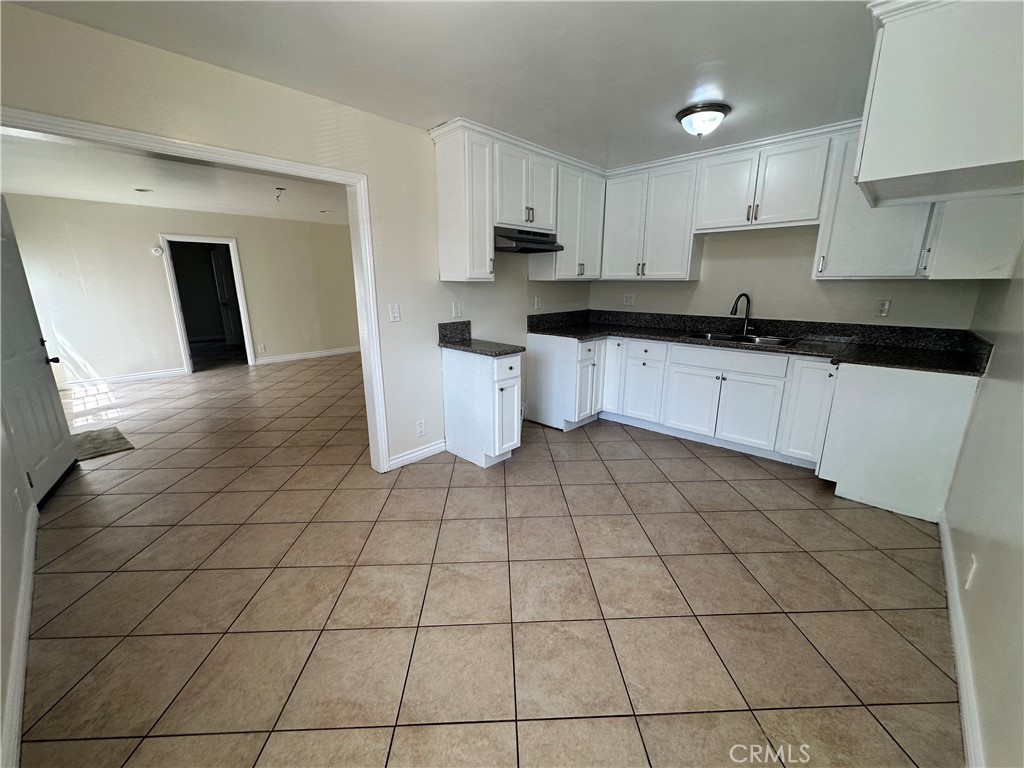 10516 Clovis Avenue Los Angeles, CA 90002 - Photo 2 of 13 a kitchen with a sink cabinets and a stove top oven
