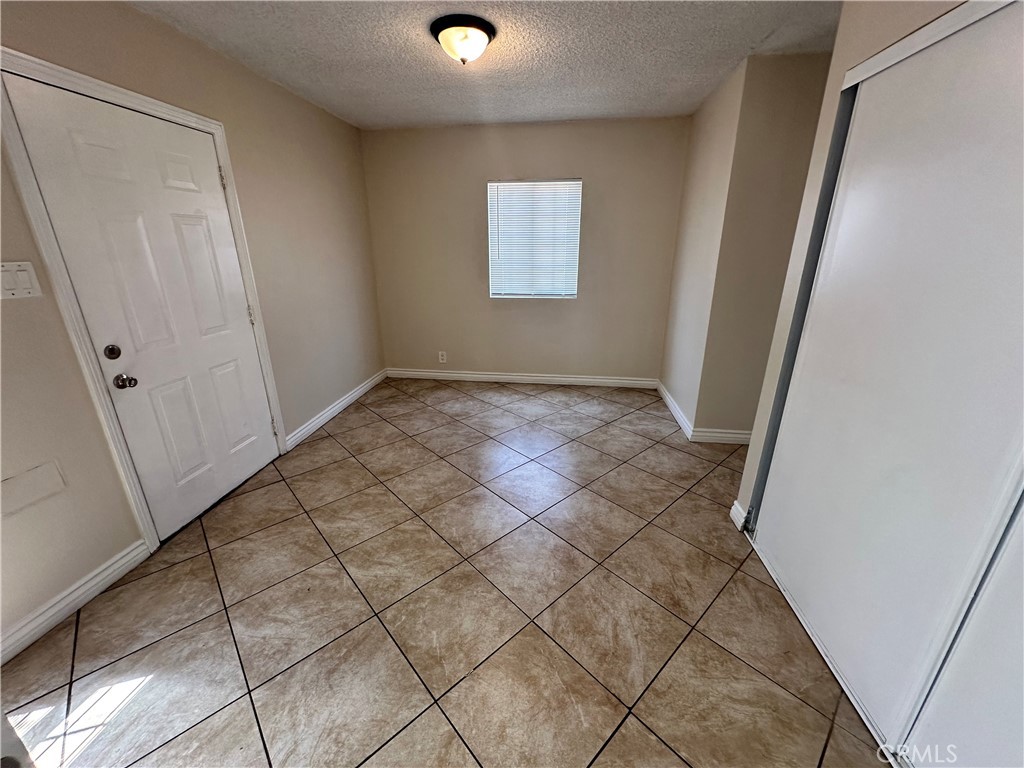 10516 Clovis Avenue Los Angeles, CA 90002 - Photo 8 of 13 an empty room with windows