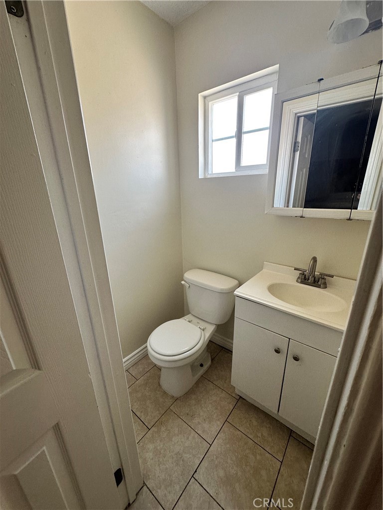 10516 Clovis Avenue Los Angeles, CA 90002 - Photo 10 of 13 a bathroom with a toilet sink and mirror