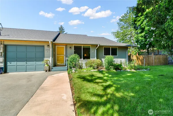 a front view of a house with a yard and porch