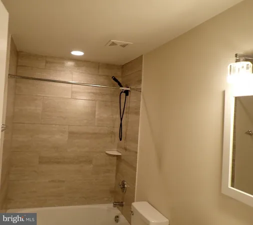 a bathroom with a shower and a toilet