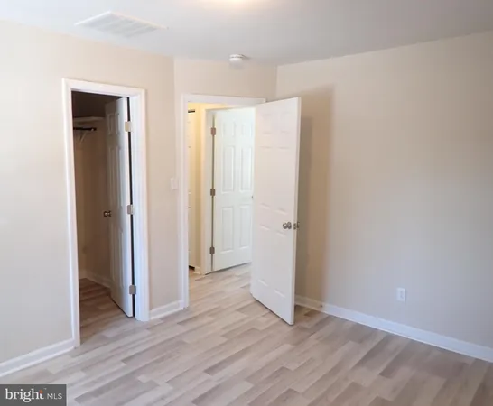a view of an empty room and wooden floor