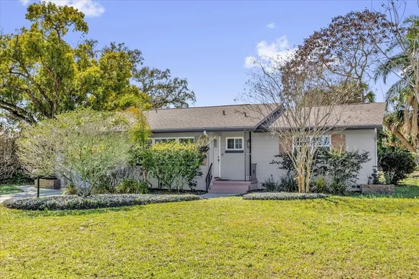 a front view of house with swimming pool and yard