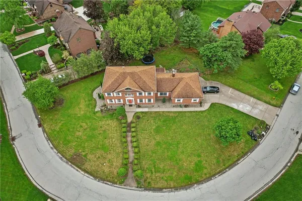an aerial view of a house with garden space and street view