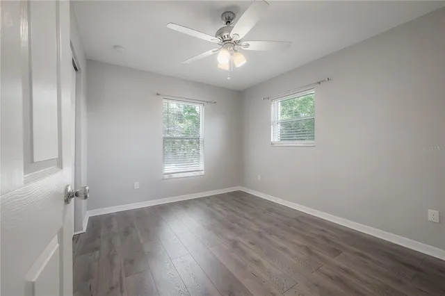 wooden floor in an empty room with a window