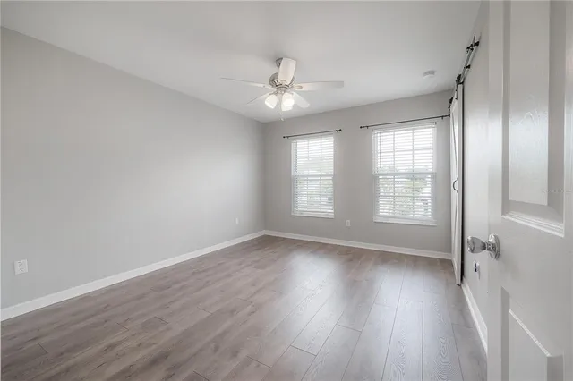 wooden floor in an empty room with a window