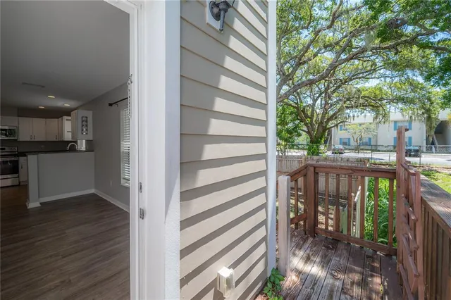 a view of a balcony with wooden floor and fence