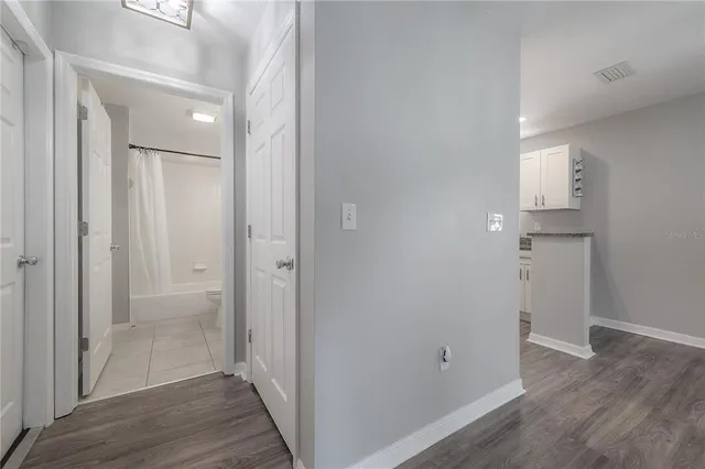 a view of a room with wooden floor