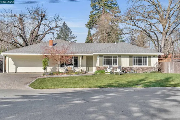 a front view of a house with a garden and patio