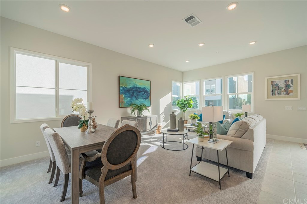 219 Chorus Irvine, CA 92618 - Photo 9 of 24 a living room with furniture a large window and a fireplace