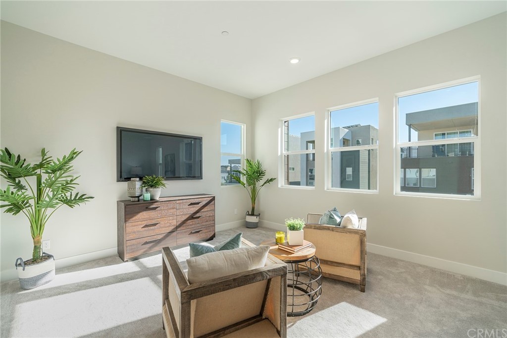 219 Chorus Irvine, CA 92618 - Photo 11 of 24 a living room with furniture a potted plant and a flat screen tv