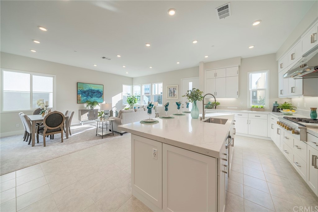 219 Chorus Irvine, CA 92618 - Photo 23 of 24 a kitchen with counter top sink cabinets and living room view