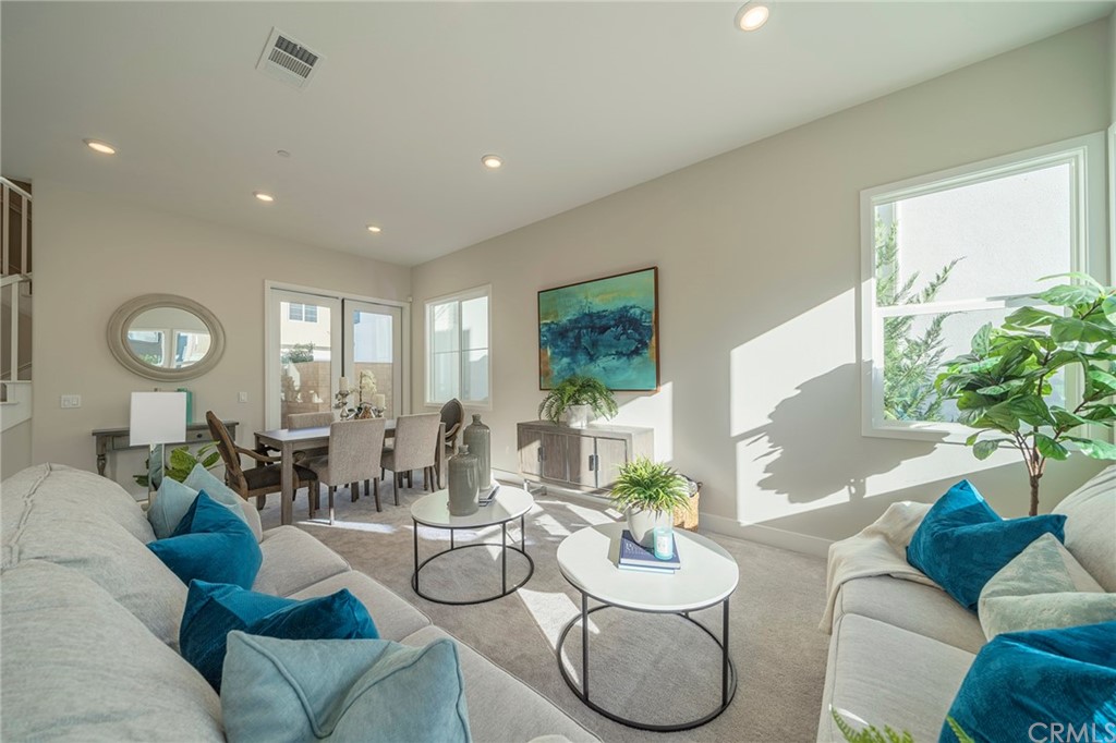 219 Chorus Irvine, CA 92618 - Photo 2 of 24 a living room with furniture and a large window