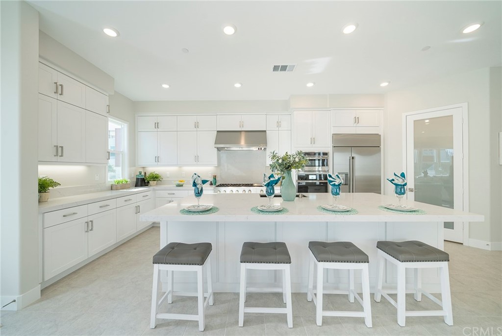 219 Chorus Irvine, CA 92618 - Photo 3 of 24 a kitchen with granite countertop cabinets and chairs