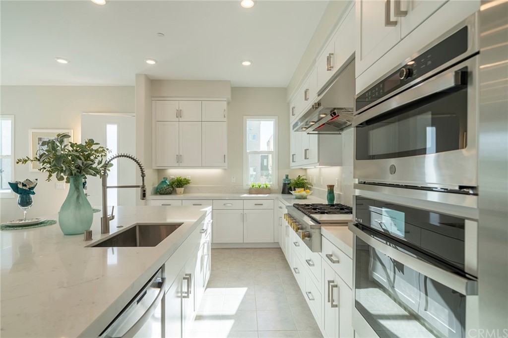 219 Chorus Irvine, CA 92618 - Photo 6 of 24 a kitchen with a sink stove and cabinets