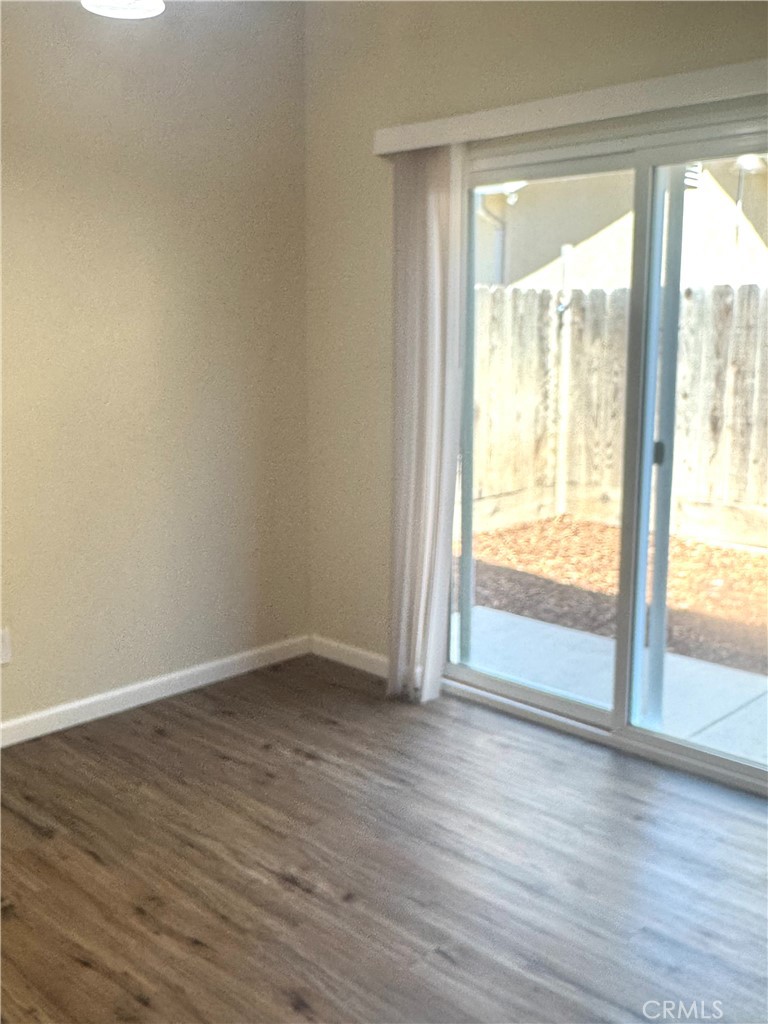 1339 Playa Del Rey Drive Merced, CA 95348 - Photo 12 of 48 a view of an empty room and wooden floor and a window