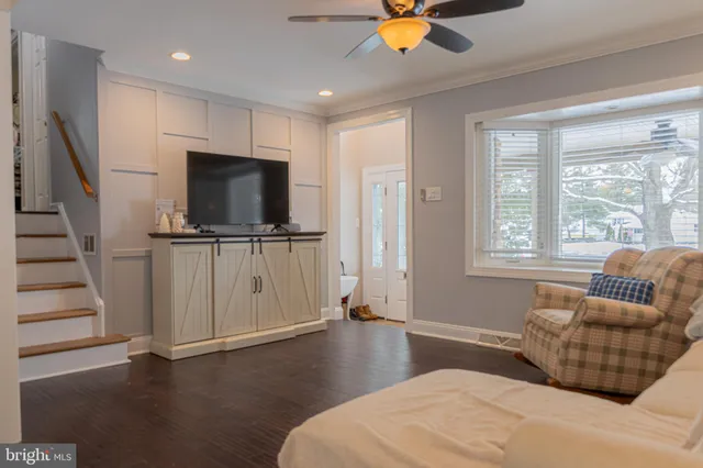 a living room with furniture and kitchen view
